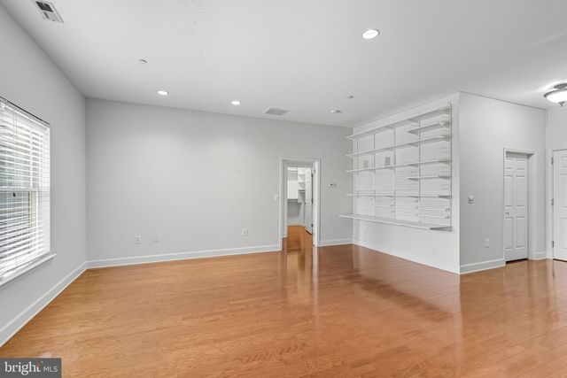 an empty room with cabinet and windows
