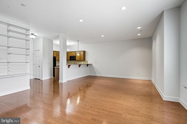 a view of a kitchen with a sink and a refrigerator