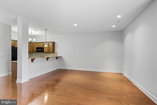 a view of a kitchen with microwave and refrigerator