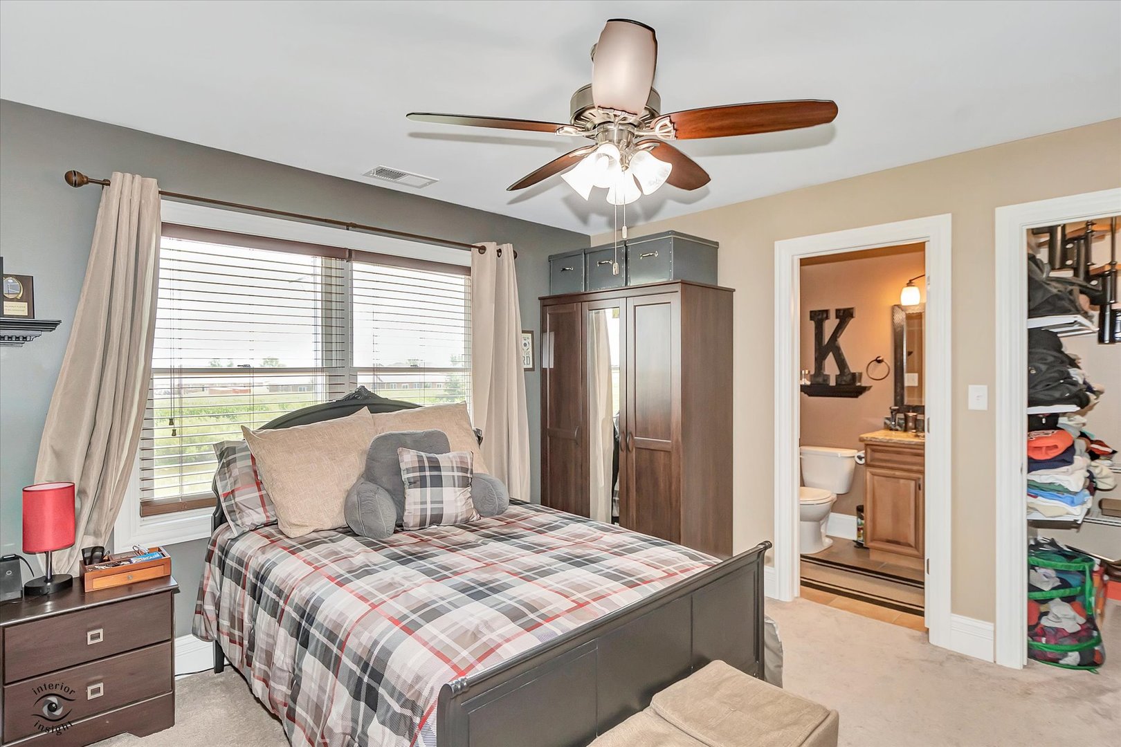 23933 Roberts Street Manhattan, IL 60442 - Photo 16 of 26 a bedroom with a bed and a chandelier