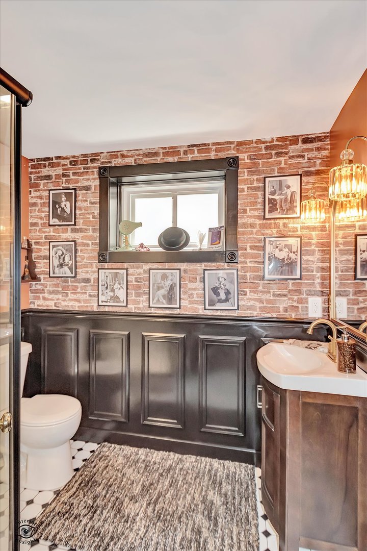 23933 Roberts Street Manhattan, IL 60442 - Photo 20 of 26 a bathroom with a granite countertop sink and a toilet