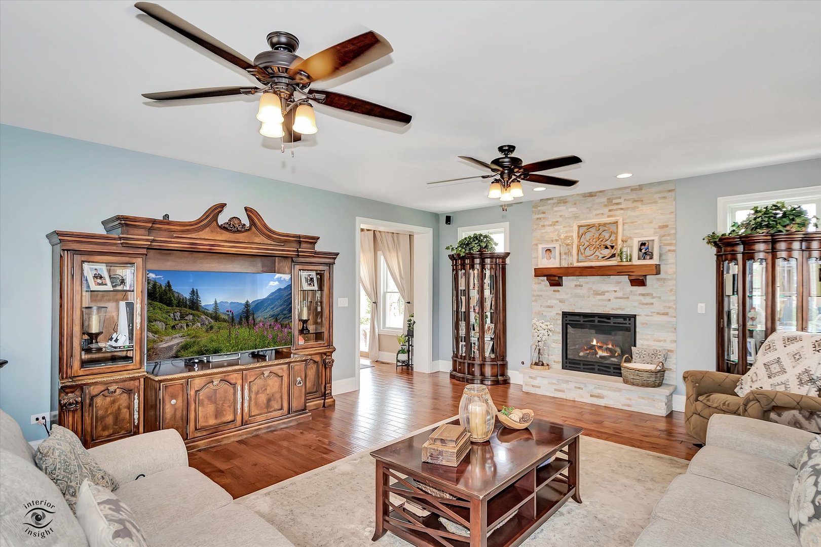 23933 Roberts Street Manhattan, IL 60442 - Photo 3 of 26 a living room with furniture a fireplace and a flat screen tv