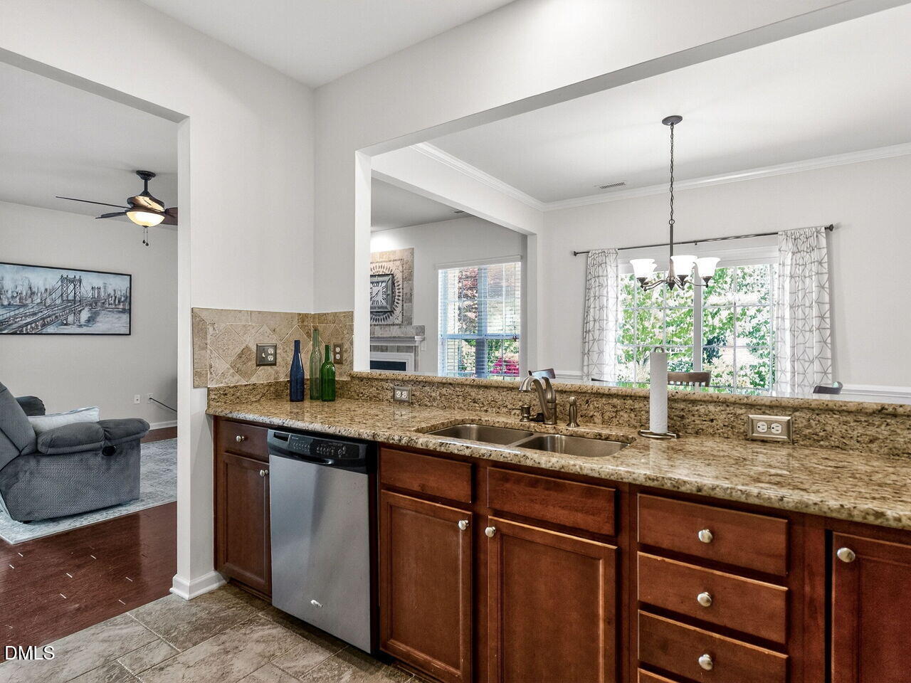 8215 Yaxley Hall Drive Raleigh, NC 27616 - Photo 17 of 42 a kitchen with kitchen island granite countertop a sink cabinets and window