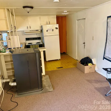 a kitchen with refrigerator and window