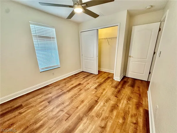 a spacious bathroom with a granite countertop sink toilet and shower