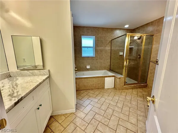 a bathroom with a tub and window