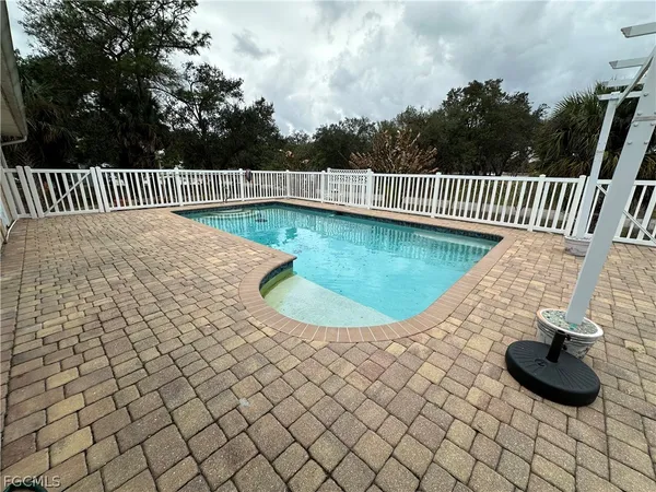 a view of a backyard with a iron fence