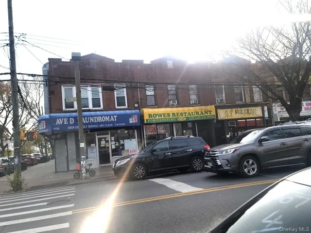 a front view of a building with parking space