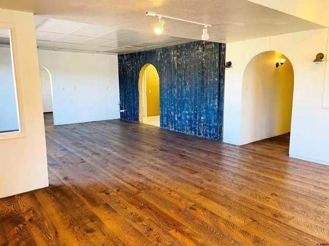 a view of a bathroom with dual sinks and wooden floor