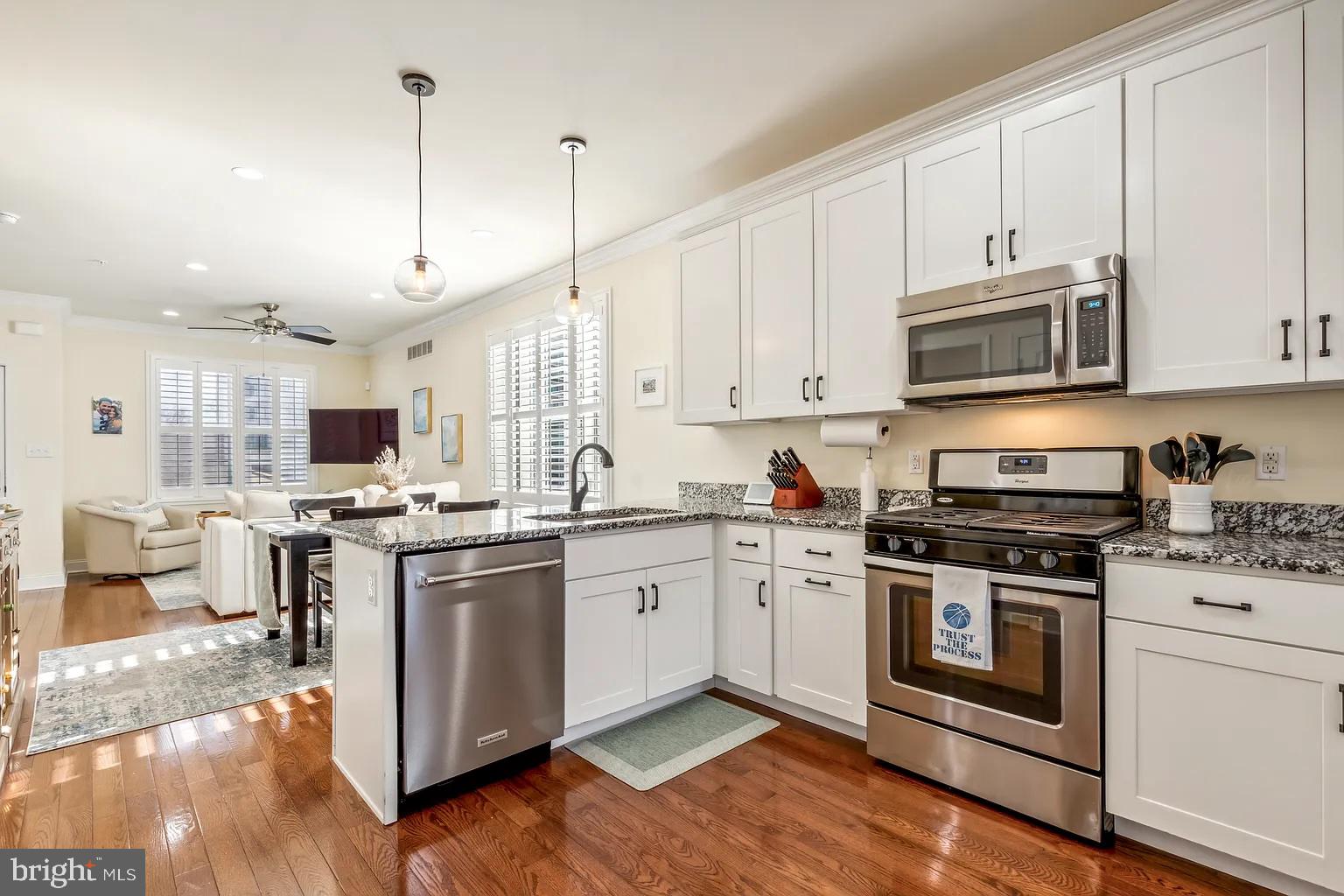 103 Front Street Conshohocken, PA 19428 - Photo 11 of 34 a kitchen with stainless steel appliances granite countertop a stove a sink and a microwave
