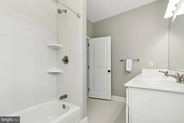 a bathroom with a sink a mirror and a bathtub
