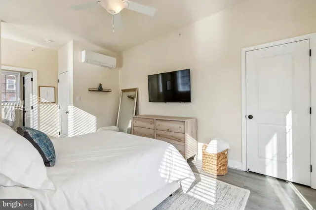 a bedroom with a bed and a flat screen tv