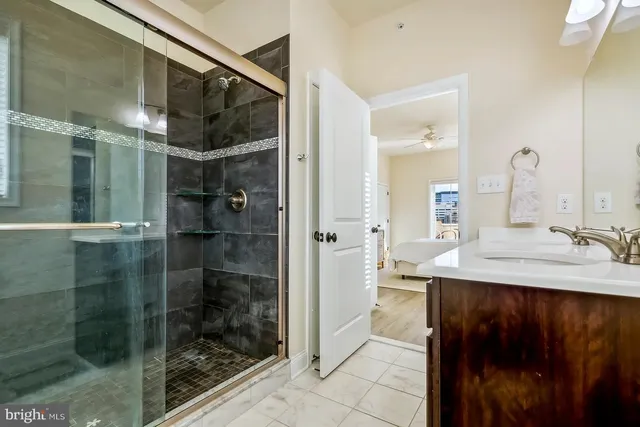 a bathroom with a shower sink and mirror