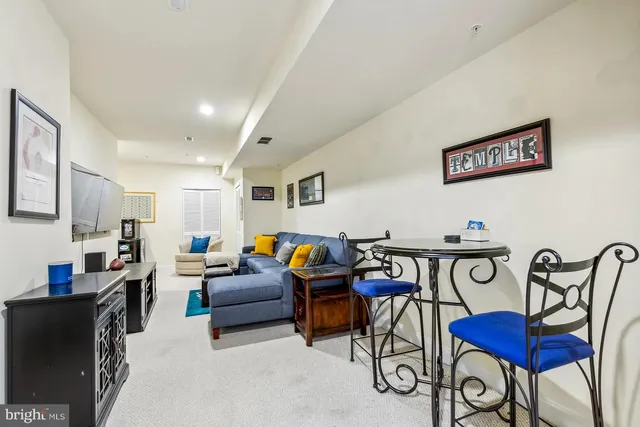 a living room with furniture a rug and a table