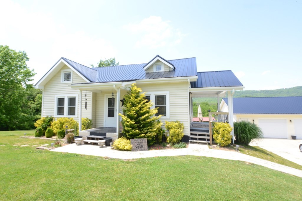 27565 Rhea County Highway Spring City, TN 37381 - Photo 30 of 30 a front view of a house with a yard and porch