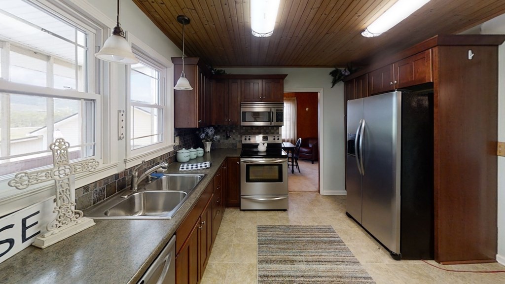 27565 Rhea County Highway Spring City, TN 37381 - Photo 8 of 30 a kitchen with stainless steel appliances granite countertop a sink a stove and a refrigerator