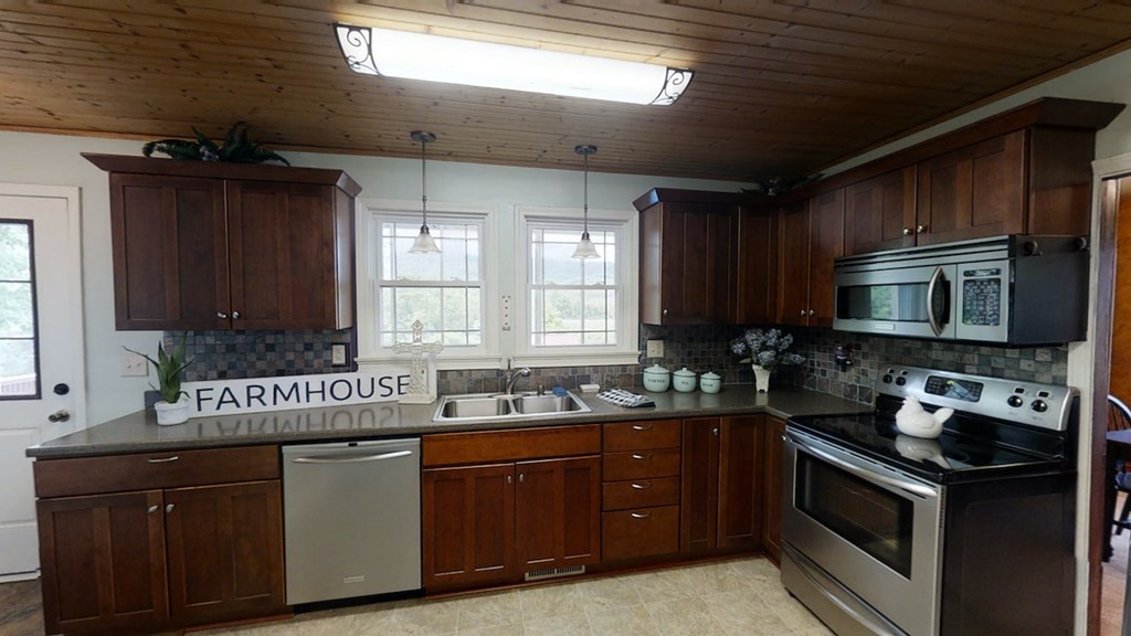 27565 Rhea County Highway Spring City, TN 37381 - Photo 10 of 30 a kitchen with a sink stove and microwave