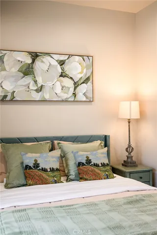 a bedroom with a bed and lamp