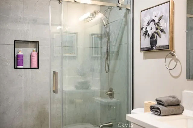 a bathroom with a shower and a sink