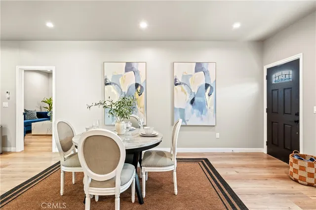 a view of a dining room with furniture wooden floor and a chandelier