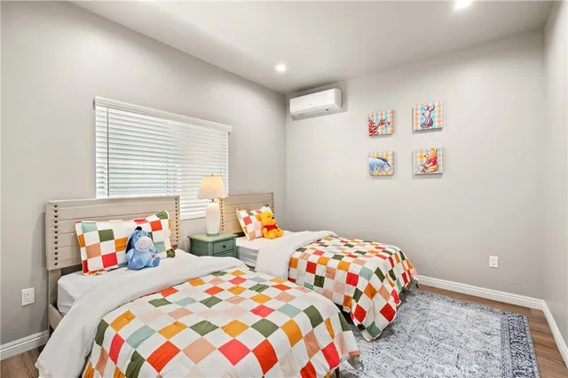 a bedroom with two beds and a painting on the wall