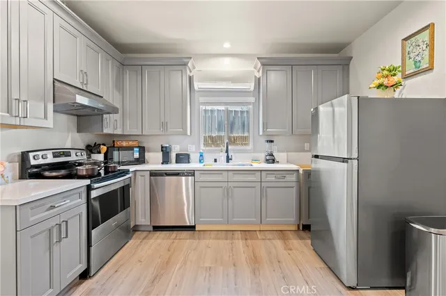 a kitchen with white cabinets and white appliances