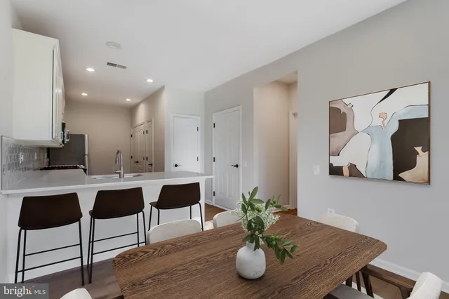 a large white kitchen with a sink and dishwasher
