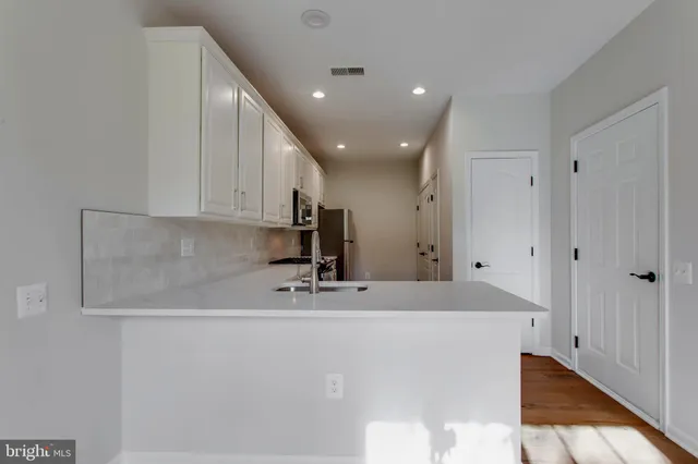 a kitchen with stainless steel appliances granite countertop a stove a refrigerator and a microwave