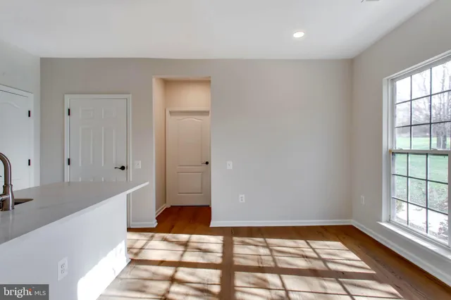 a view of a room with wooden floor