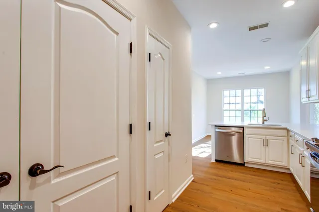 an empty room with a ceiling fan and window