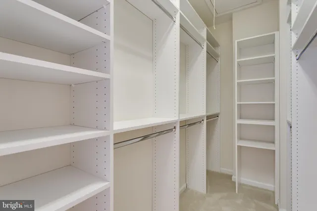 a front view of a building with large trees