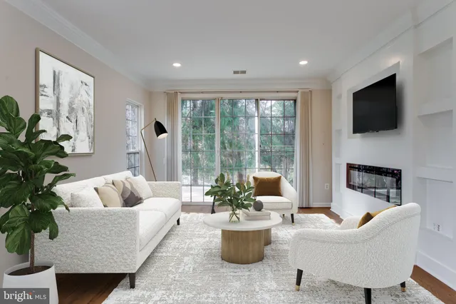a living room with furniture a flat screen tv and a large window