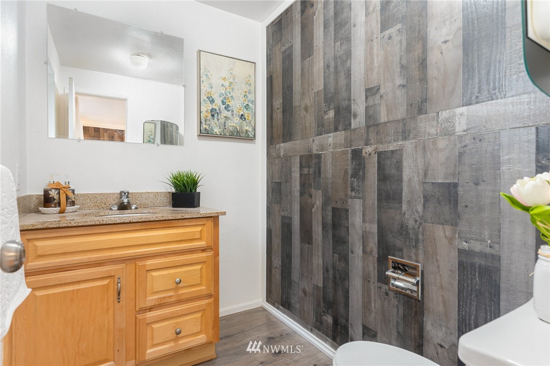 9215 Northeast 183rd Street Bothell, WA 98011 - Photo 14 of 38 a bathroom with a sink mirror vanity and toilet