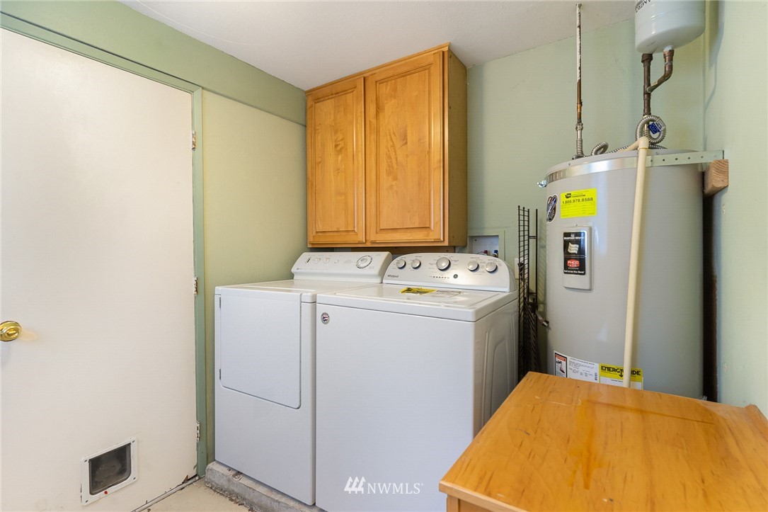 9215 Northeast 183rd Street Bothell, WA 98011 - Photo 22 of 38 a bathroom with a sink and mirror with shower