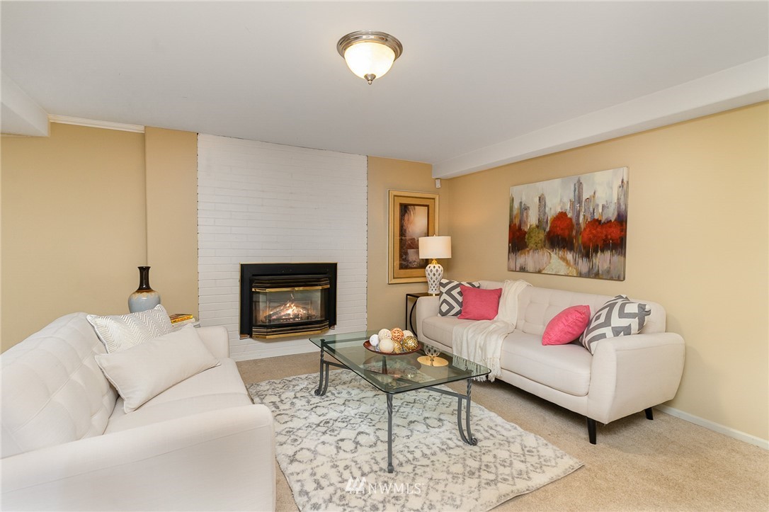 9215 Northeast 183rd Street Bothell, WA 98011 - Photo 23 of 38 a living room with furniture and a fireplace