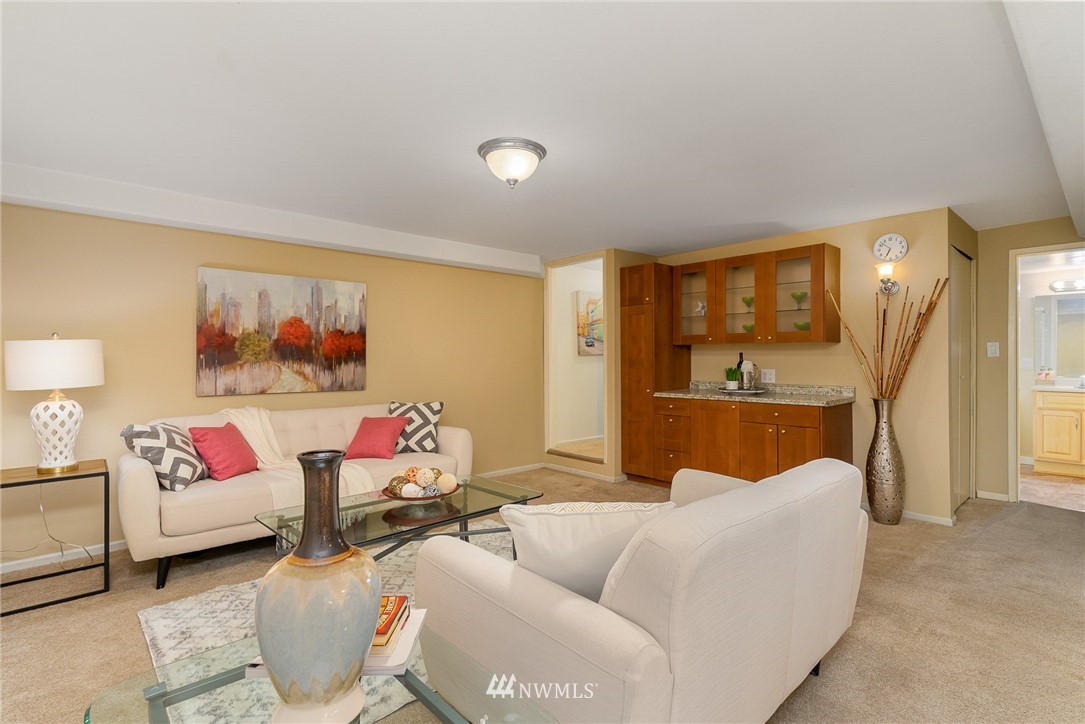 9215 Northeast 183rd Street Bothell, WA 98011 - Photo 25 of 38 a living room with furniture and a flat screen tv