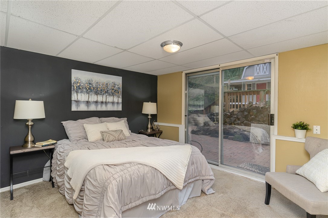 9215 Northeast 183rd Street Bothell, WA 98011 - Photo 26 of 38 a spacious bedroom with a bed and a couch