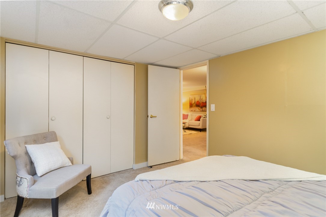 9215 Northeast 183rd Street Bothell, WA 98011 - Photo 27 of 38 a bedroom with a bed and a chair