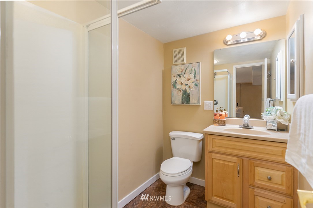 9215 Northeast 183rd Street Bothell, WA 98011 - Photo 28 of 38 a bathroom with a toilet sink and mirror