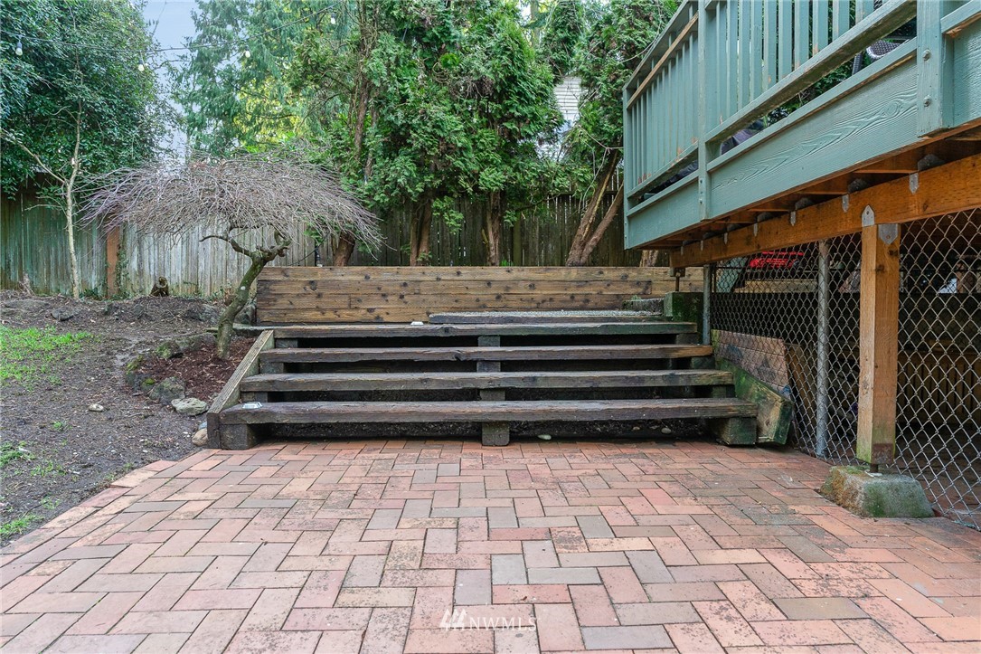 9215 Northeast 183rd Street Bothell, WA 98011 - Photo 32 of 38 a view of backyard with large trees and a wooden fence