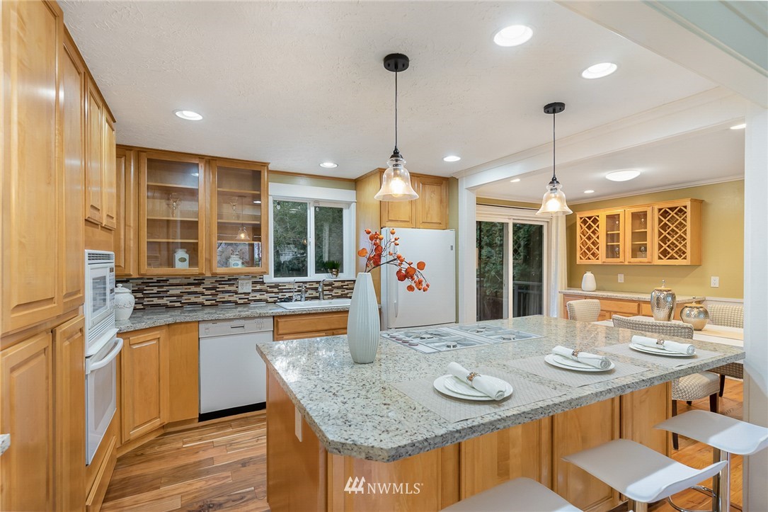 9215 Northeast 183rd Street Bothell, WA 98011 - Photo 9 of 38 a kitchen with stainless steel appliances granite countertop a kitchen island a stove and a sink