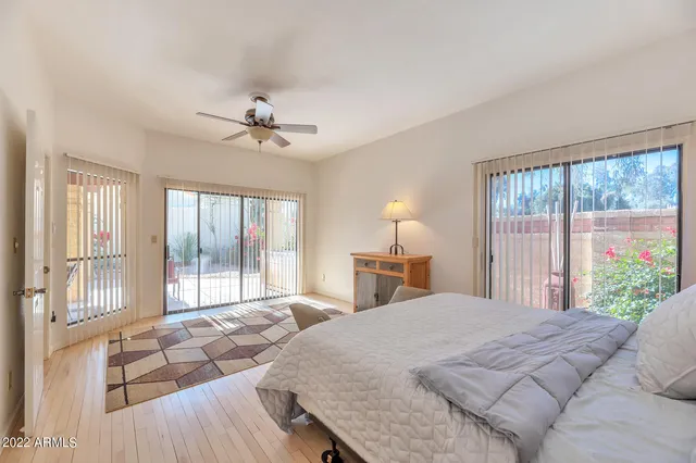 a bedroom with a large bed and a large window with outer view