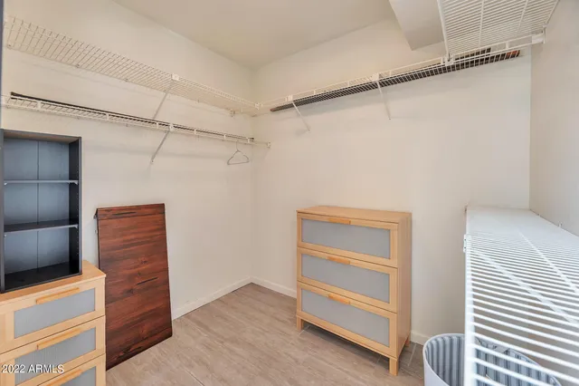 a view of walk in closet with empty racks