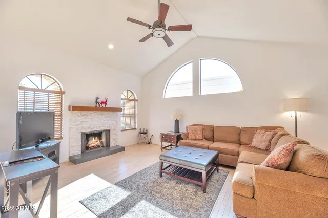 a living room with furniture a fireplace and a flat screen tv