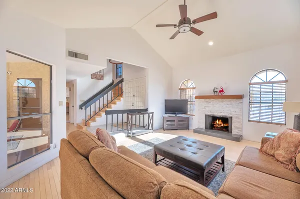 a living room with furniture fireplace and a table