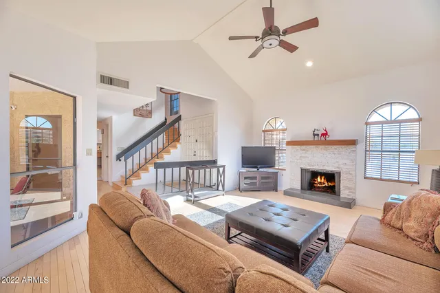 a living room with furniture fireplace and a table