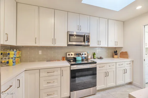 a kitchen with cabinets appliances and a sink
