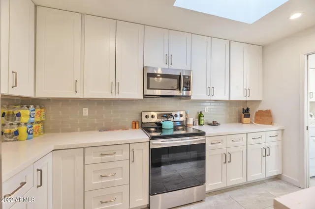 a kitchen with cabinets appliances and a sink