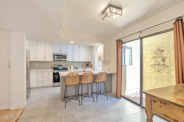 a kitchen with a stove a refrigerator and a sink