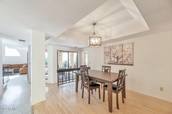 a view of a dining room with furniture wooden floor and chandelier
